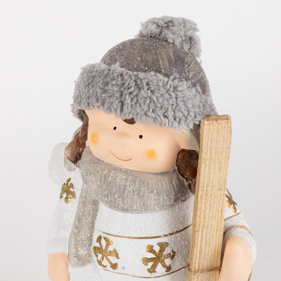 Figura decorativa de cerámica Niña con gorro y esquís 26cm