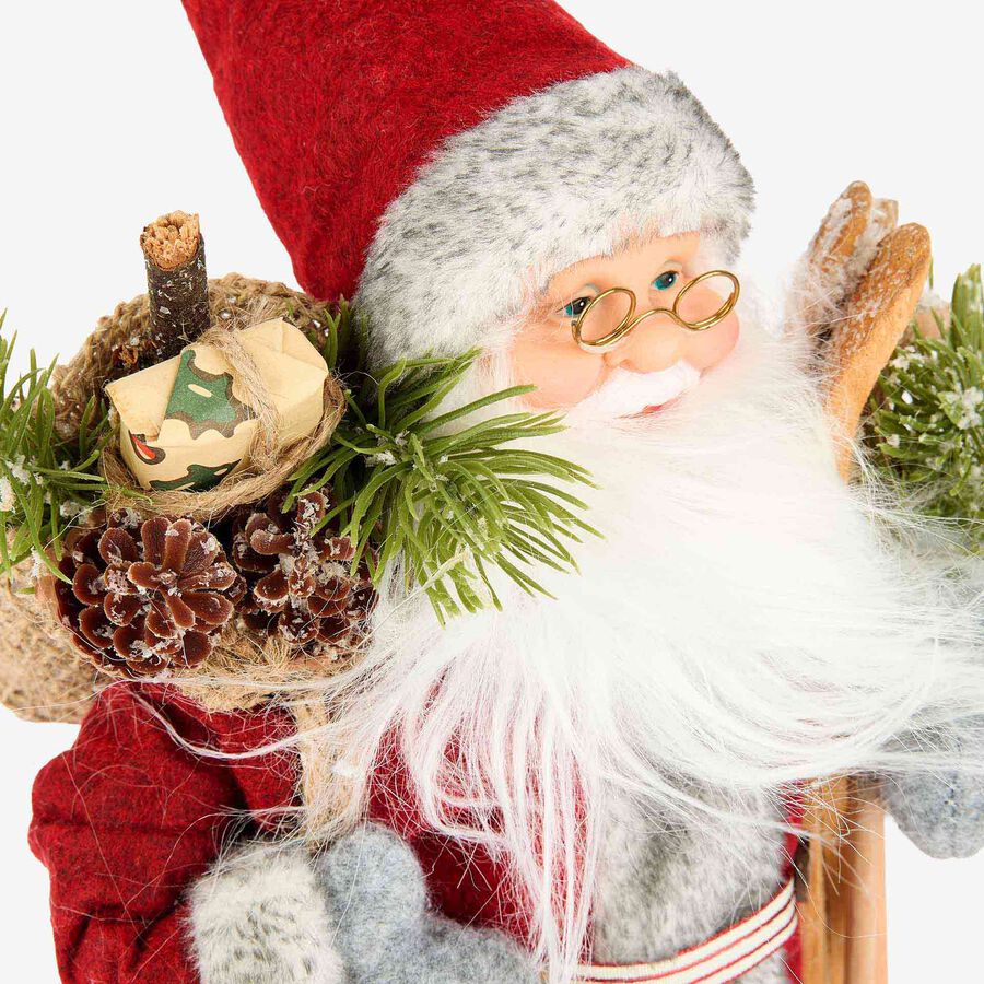 Figura decorativa Santa Claus con saco y esqu&iacute;s rojo 30cm