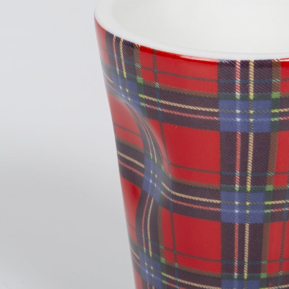 Taza de espresso de porcelana en tart&aacute;n rojo